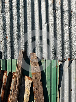 Old and rusty zinc sheet wall. Vintage style metal sheet roof texture. Pattern of old metal sheet. Rusting metal or siding.