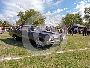 old 1960s Chevrolet Impala Super Sport 327 coupe on the lawn