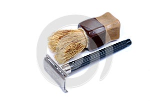 The old safety razor and small brush on a white background. Personal care products for shaving.