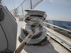 old sailboat sheet winch sail detail Yachting. Sailing winch and rope of a yacht. Sheet. Cable. pulley