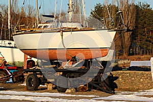 Old sailboats and yachts on the shore at winter