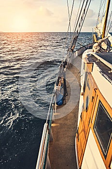 Old sailing schooner at sunset, color toning applied