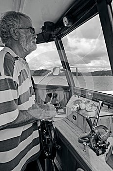 Old sailor navigating his boat