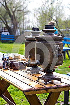 An old samovar on a table in the garden