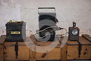 Old Sanson car battery along with a Philips battery charger and a workshop lantern