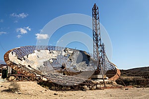 Old satellite dish antenna in dry adir land near El Medano, Tenerife, Canary Islands, Spain, telecommunication photo