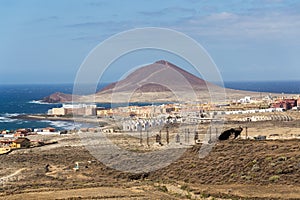 Old satellite dish antenna in dry adir land near El Medano, Tenerife, Canary Islands, Spain, telecommunication photo