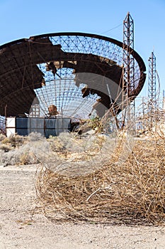 Old satellite dish antenna in dry adir land near El Medano, Tenerife, Canary Islands, Spain, telecommunication photo