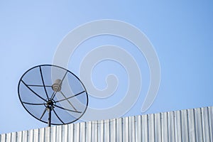 Old satellite dish on the blue sky background