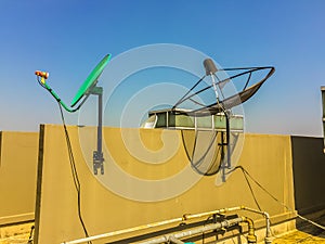 Old satellite dishes on concrete deck top roof floor of the old