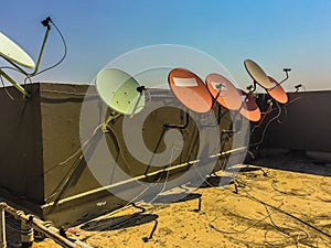 Old satellite dishes on concrete deck top roof floor of the old