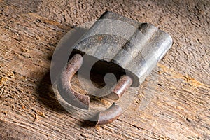 An old sawn lock on a wooden surface.