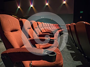 Old school empty movie theater with orange seats