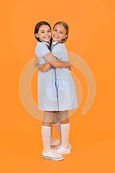 Old school. kid fashion. happy friends embrace on yellow background. fashion beauty. childhood happiness. sisterhood of