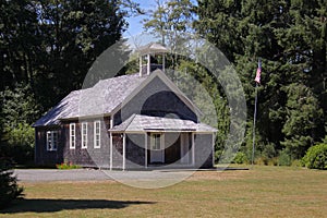 Old schoolhouse with flagpole photo