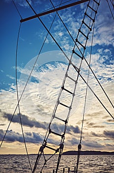 Old schooner rope ladder and rigging silhouette at sunset