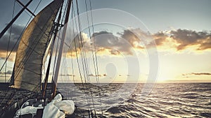 Old schooner sailing at sunset