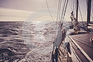 Old schooner sailing at sunset