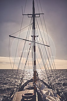 Old schooner sailing at sunset