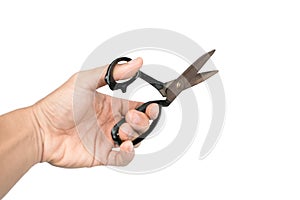 Old scissors in boy's hand. Isolated on white background