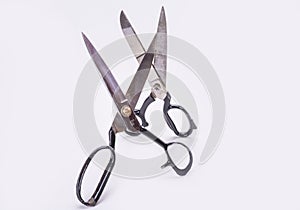 Old scissors two pairs on white background standing up.