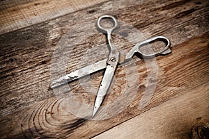 Old scissors on the wooden table