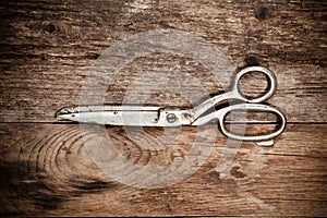 Old scissors on the wooden table