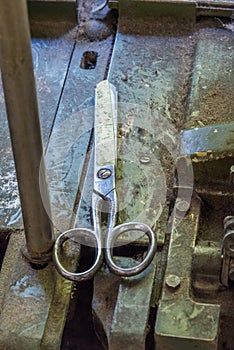 Old scissors on a working desk