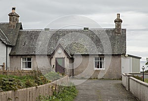 Old scottish house painted pink with a purpe door