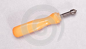 Old screwdriver used with orange plastic handle isolated