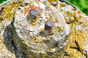 Old screws in stone