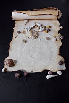 Old scroll of parchment with sea pebbles and