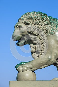 Old sculpture of a lion at the Palace pier. Saint Petersburg