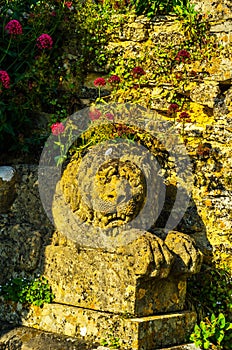 Old sculpture on the pedestal, beautifully preserved old artistic figure, decorative elements on the outside