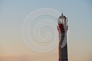Old sea lighthouse against the sky in Paldiski, close-up photo