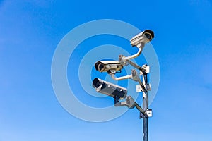 Old security camera or CCTV sits on a pole