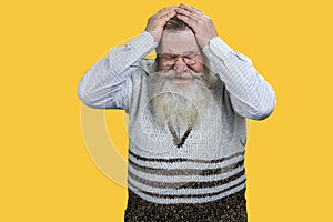 Old senior bearded man suffering from headache.