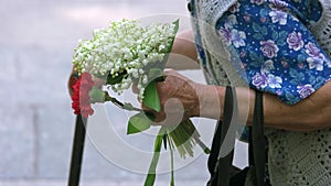 Old senior grandma with flowers during memorial day.