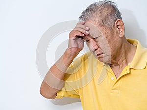 Old senior man suffering and covering face with hands in headache and deep depression. emotional disorder, grief and desperation