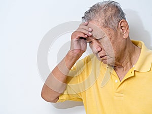 Old senior man suffering and covering face with hands in headache and deep depression. emotional disorder, grief and desperation photo