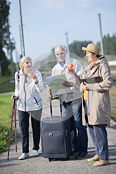 Old seniors people looking at map on traveling journey during pandemic.COVID-19 travel in the New Normal