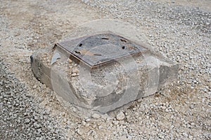 Old sewer entrance during road constructions. Metal manhole or metal hatch