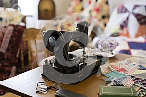 Old sewing machine on the desktop in the workshop