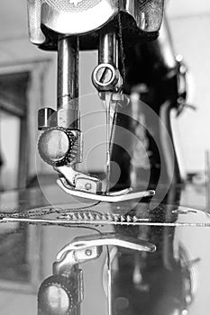 Old sewing machine stands on the table at home ready to work and sew.