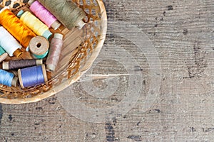 Old sewing tools on the old wooden background