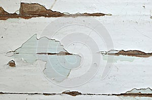 Old shabby, breakaway white paint from the wooden structure in the apartment.