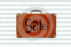 Old shabby brown suitcase watercolor blue stripes background with sign Sale on it.