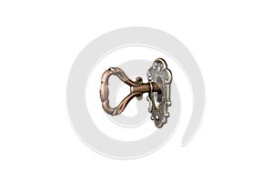 Old shabby key in keyhole on white background