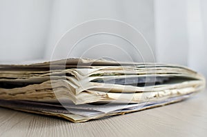 An old shabby notepad with notes lies on the table. Close-up, selective focus