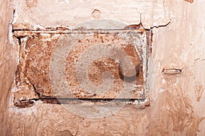 Old shabby and rusty metal door of brick furnace in country house